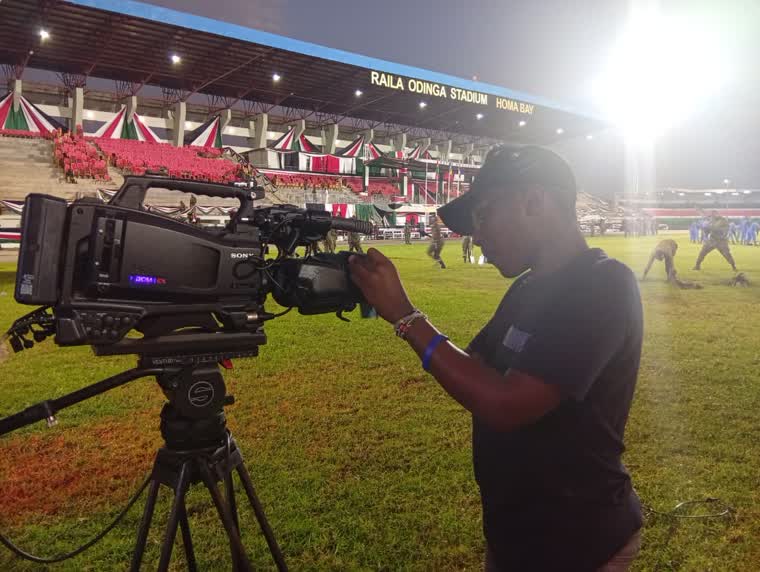 Camera operator rigging at Raila Odinga Stadium, Homa Bay, under floodlights