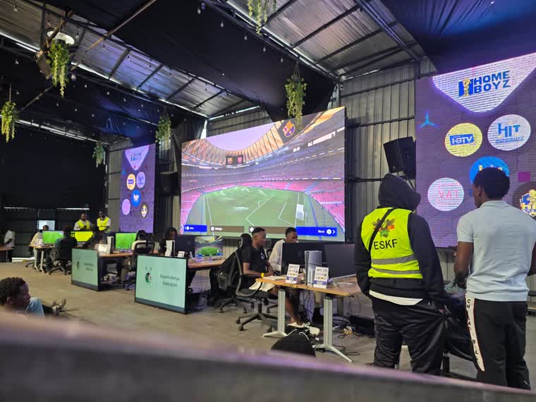 Esports players in front of a branded LED wall